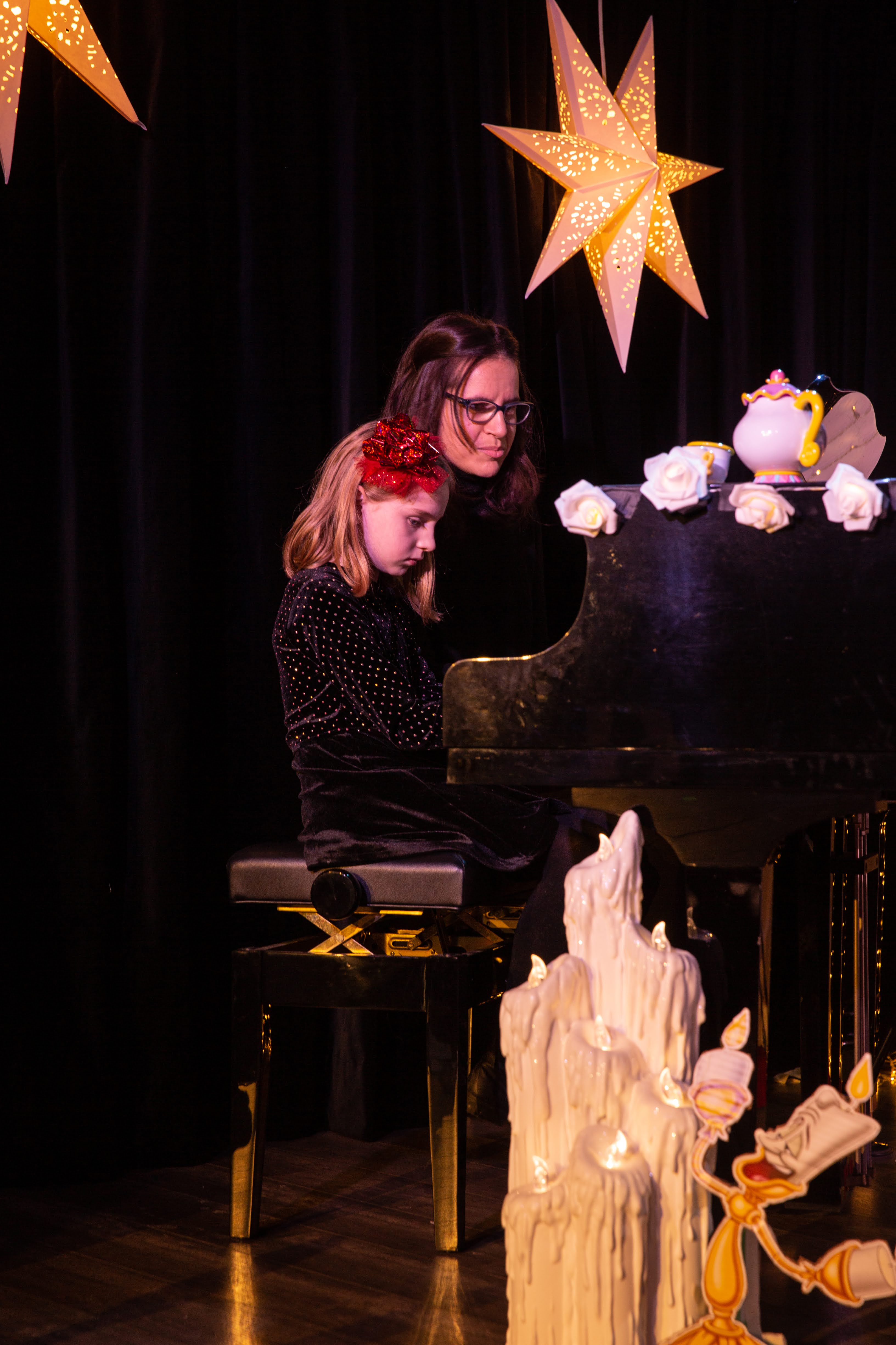 instructor teaching her student the piano