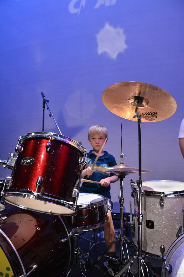 a young boy mastering the drums