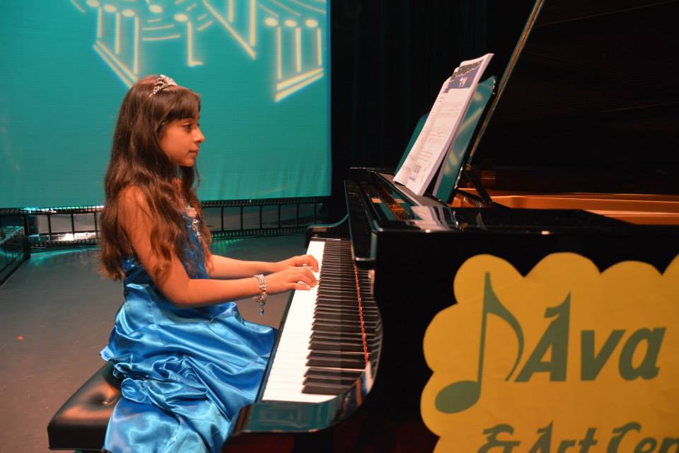 child mastering the piano