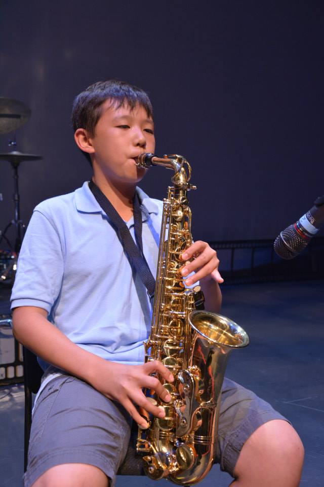 kid mastering the saxophone