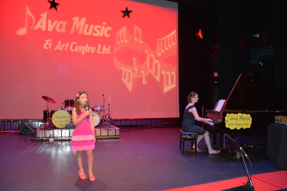 child singing and instructor with the piano