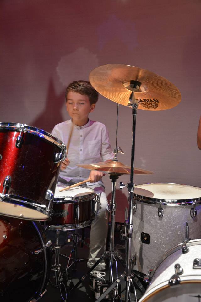 kid playing the drums masterfully