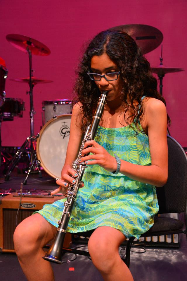 A girl playing the flute masterfully