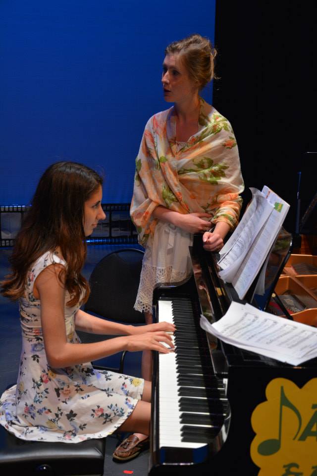 teaching her mentee the way of the piano