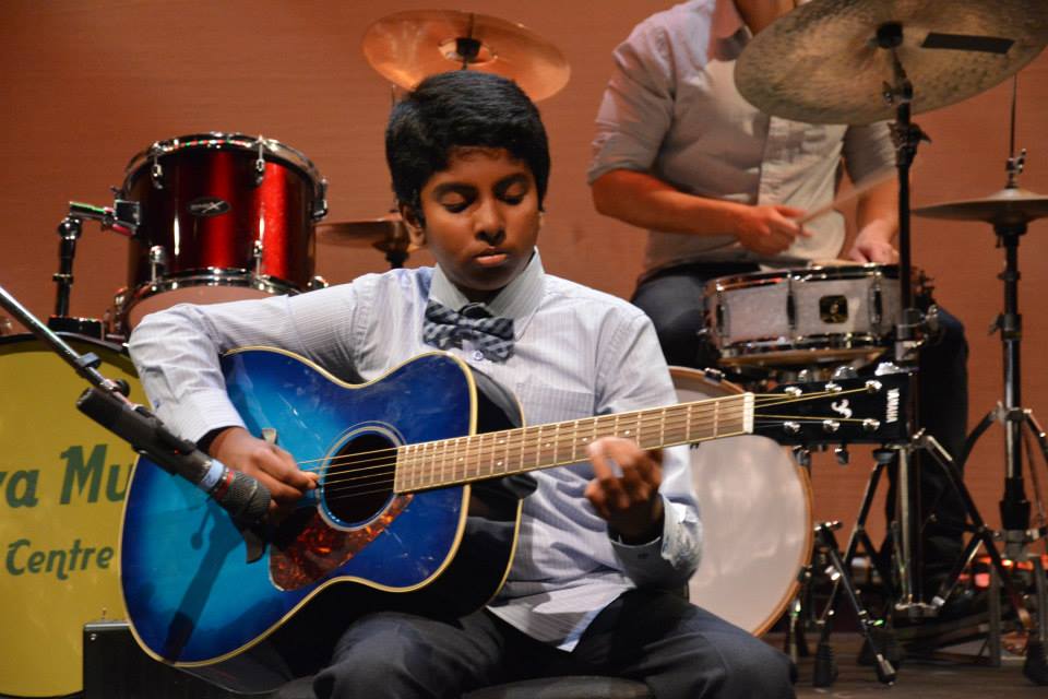 boy mastering the guitar