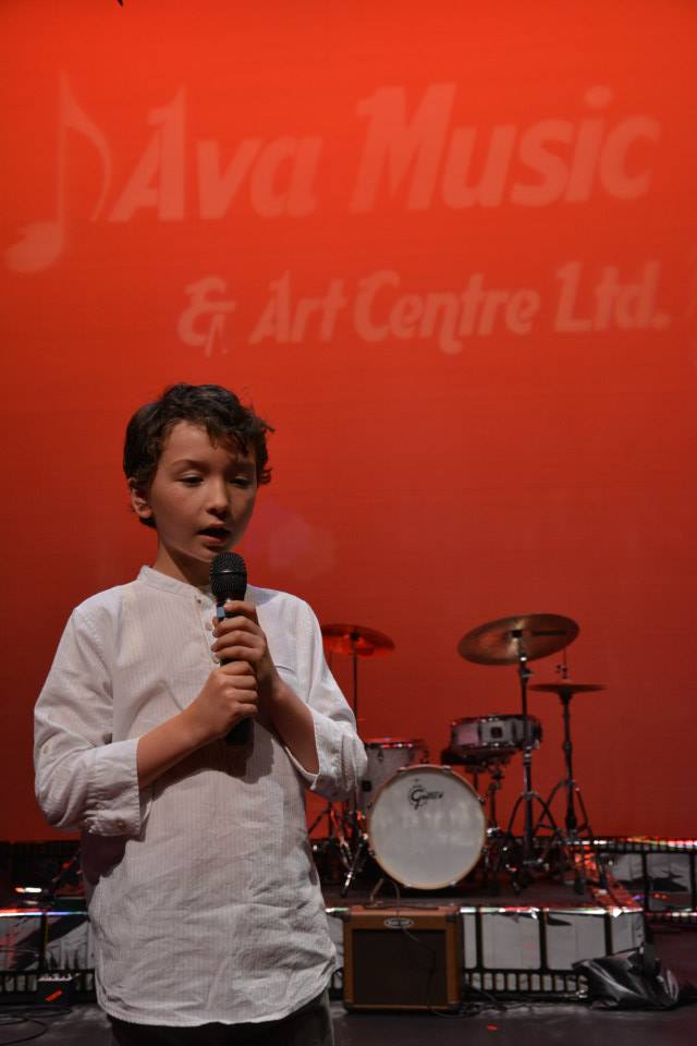 a boy singing with confidence