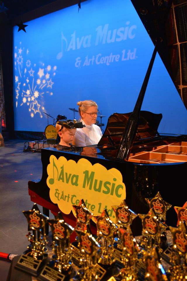 kid and instructor with the piano