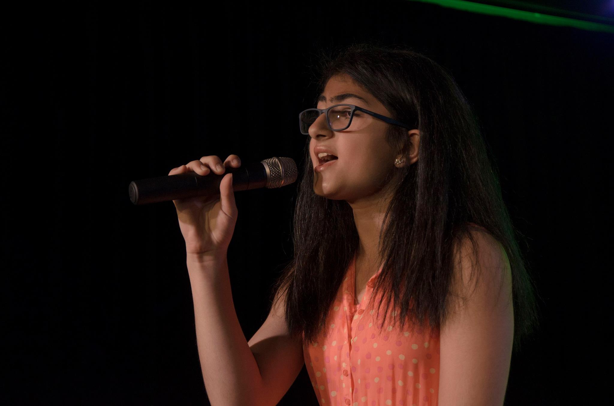 A girl happily singing with content