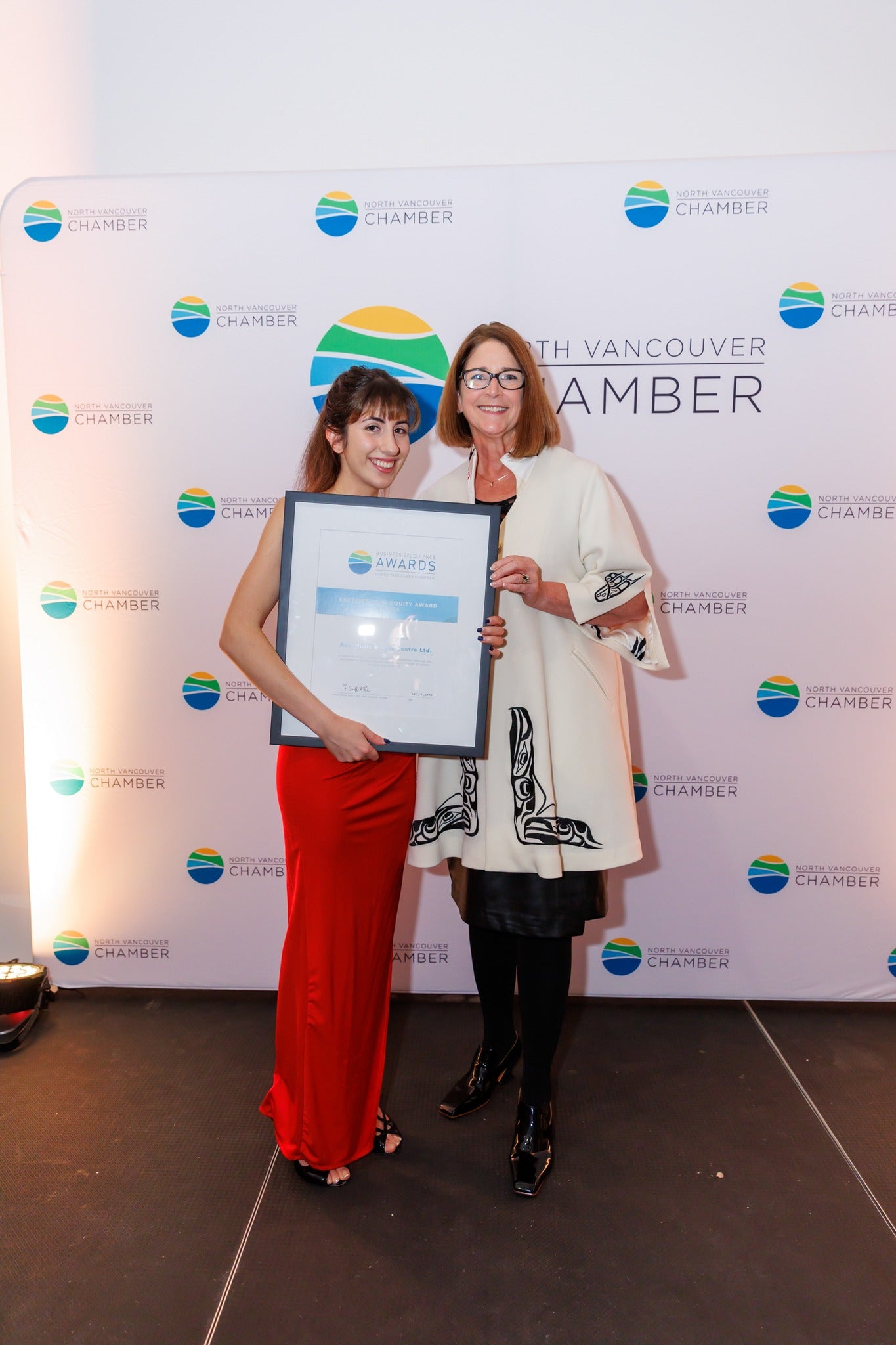 two ladies receiving an award at nvc