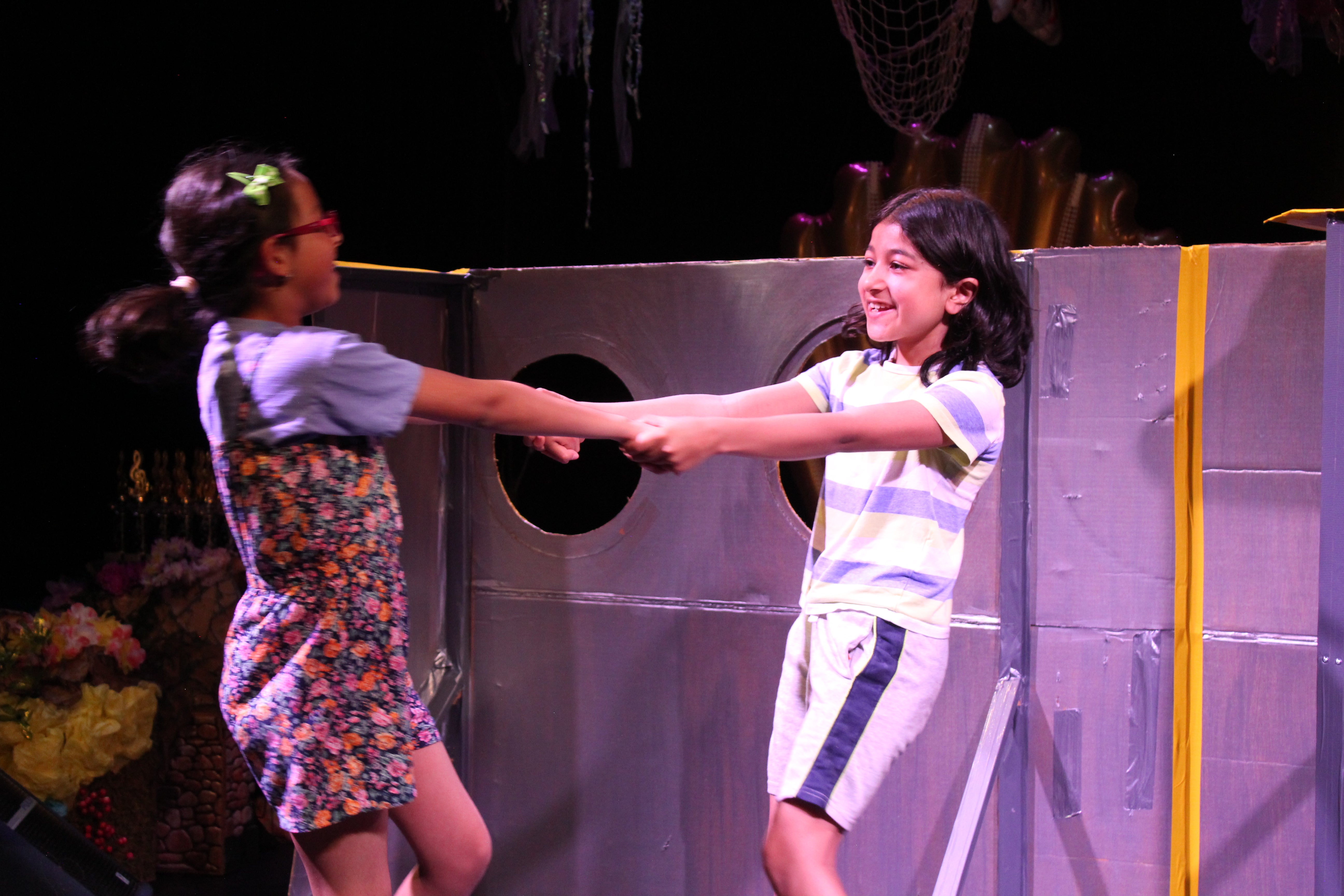 two girls enjoying the theatre