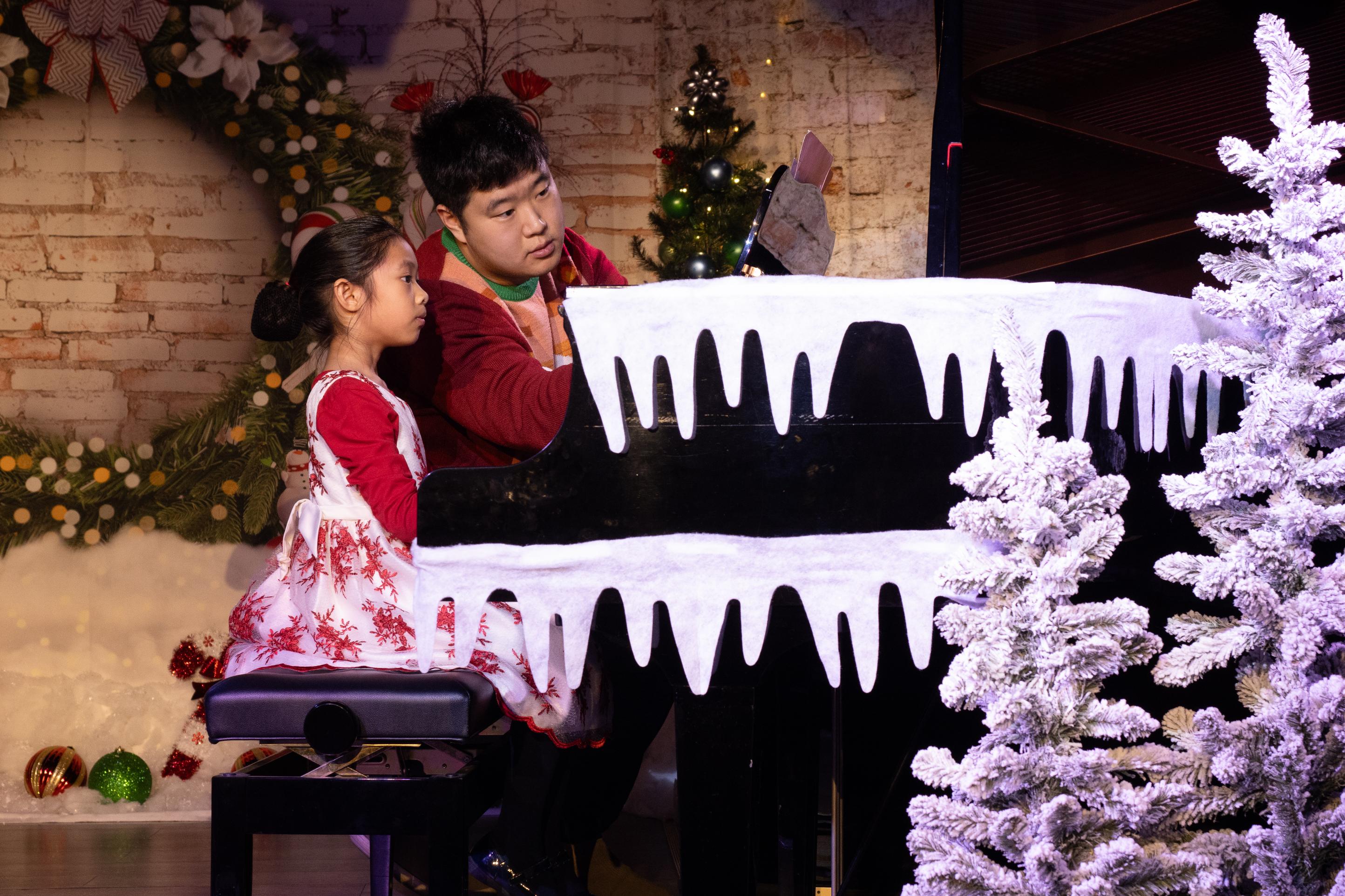 Children performing piano at winter recital