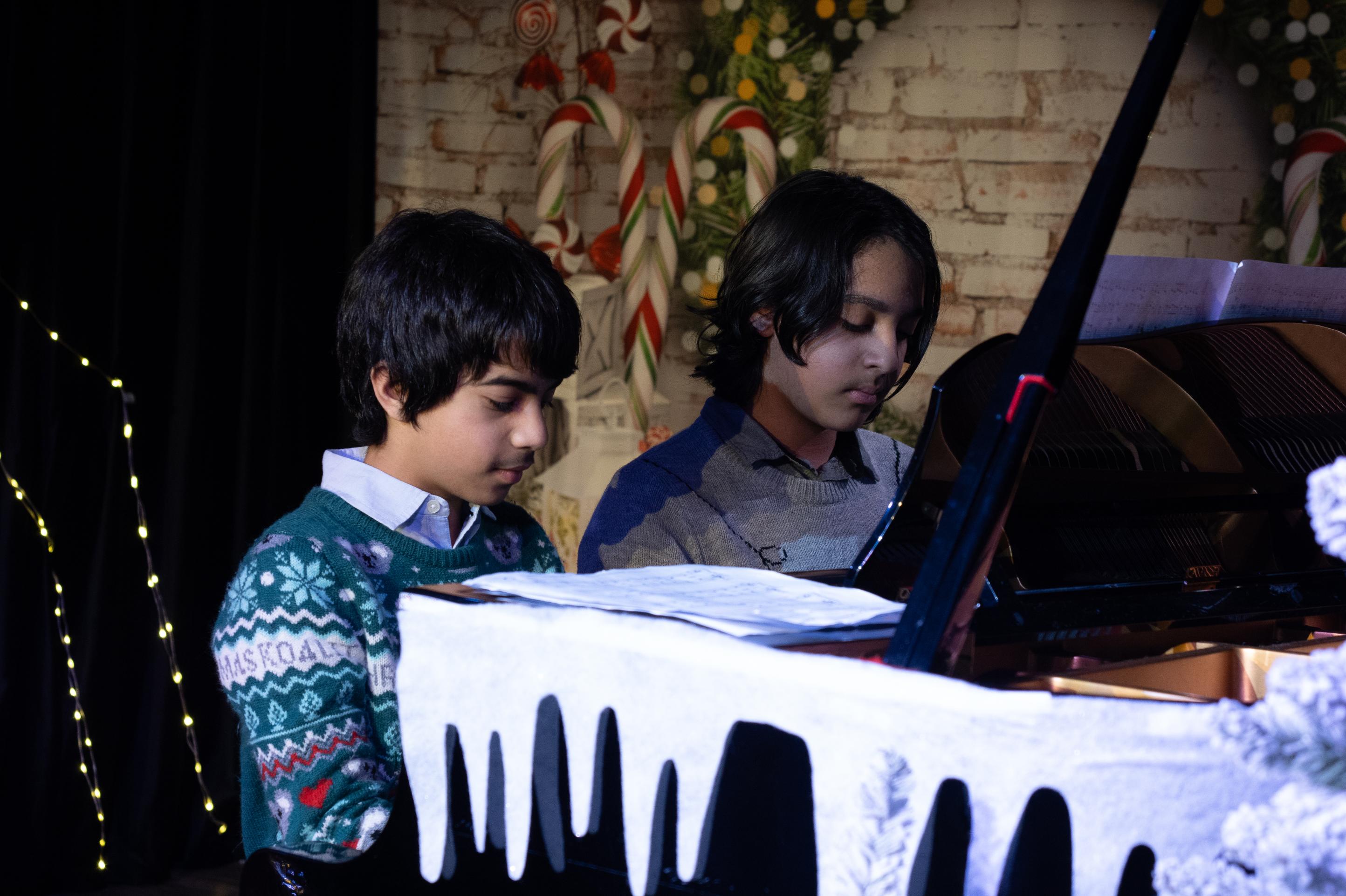 Child musicians at piano during festive concert