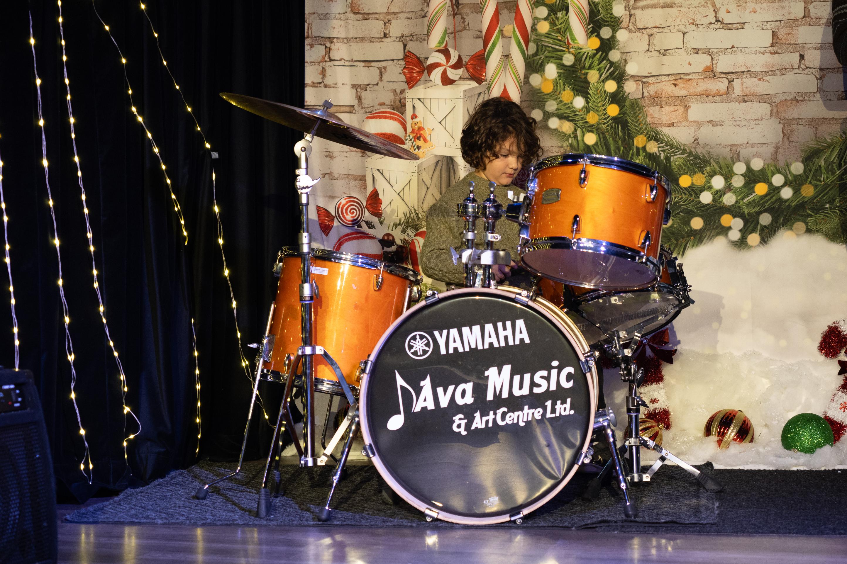 Young percussionist energetically playing the drums