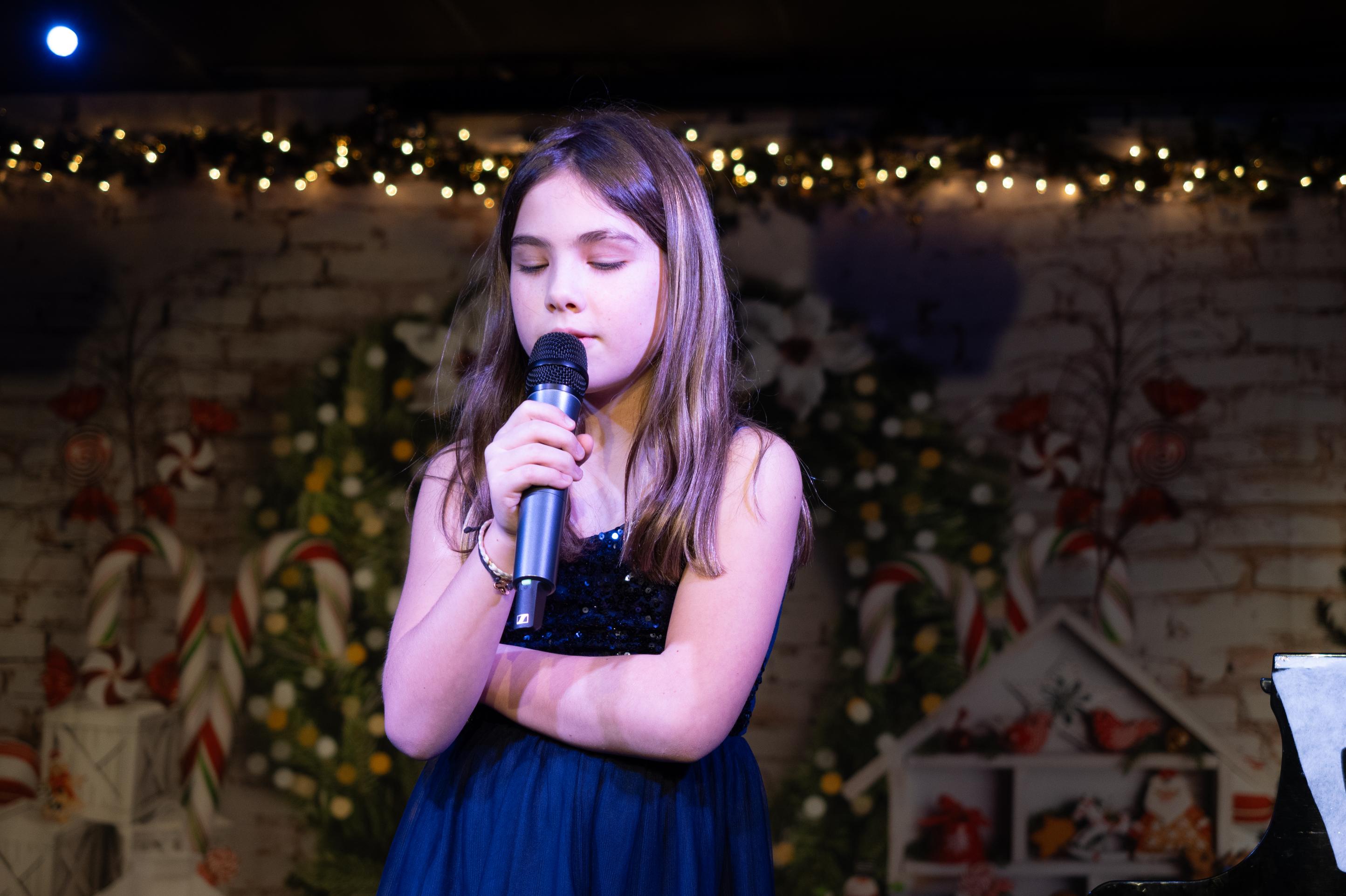 Young vocalist showcasing talent in a live performance